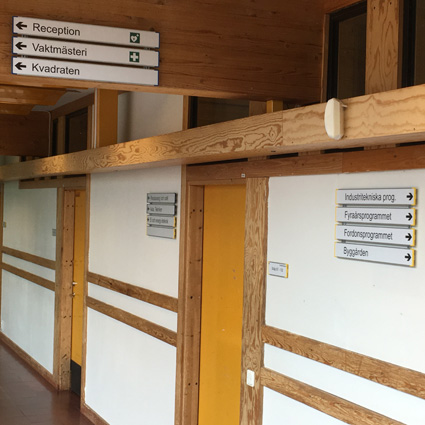 Hänvisning med väggmonterade signcode 600x65mm i Längen på Ullvigymnasiet i Köping